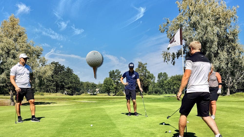 golf course with players on the green