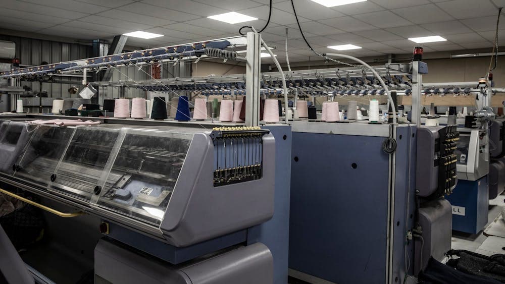 Rows of flatbed knitting machines in the factory