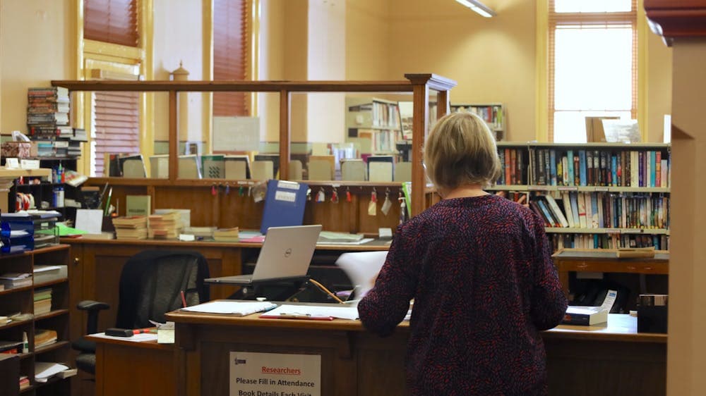 Photo of librarian working behind a desk