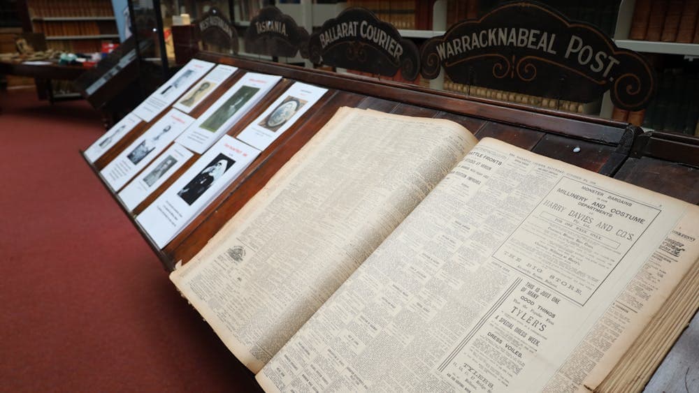 Photo of an old newspaper sitting on a reading desk