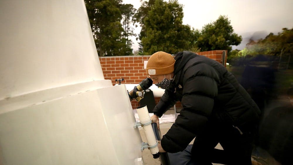 Person looking into the eyepiece on  the Federation Adcock Telescope