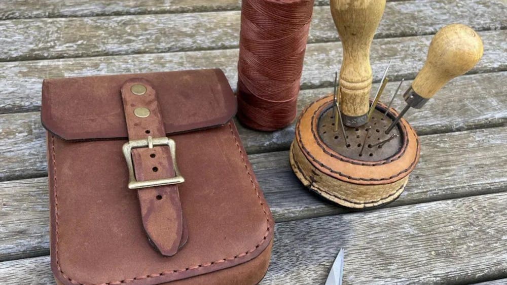 Leather buckled pouch with utensils