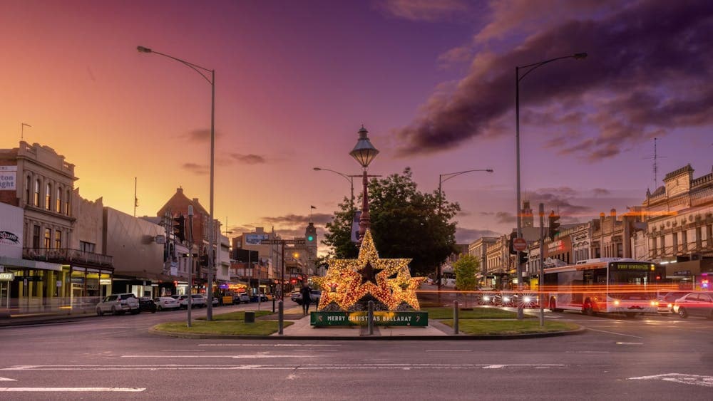 Three stars lit up with fairy lights at sunset