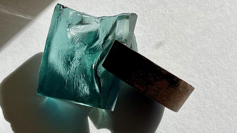 Sculpture made of blue cast glass and metal found object,