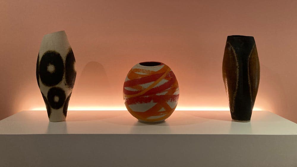 Three large ceramic pots, each with significant graphic treatments