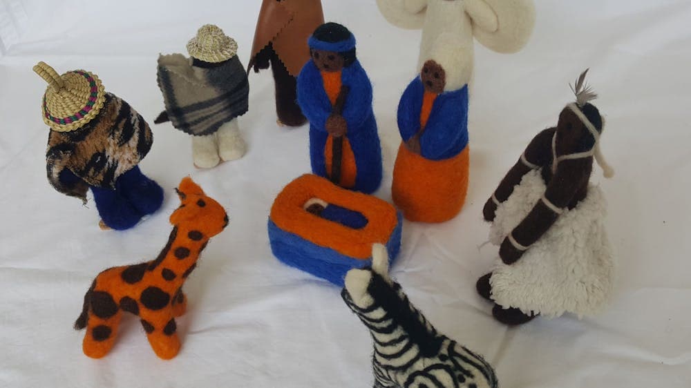 Felt figures in bright colours, including a giraffe and a zebra