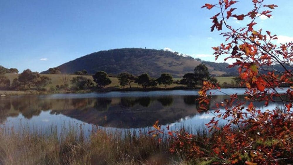 Mount Buninyong on a clear day with water in foreground