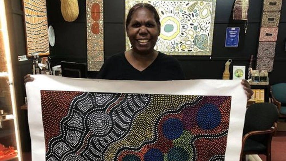 Artist holding her painting