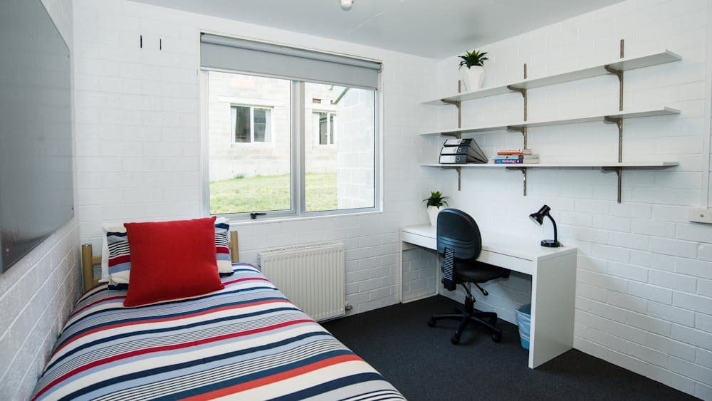 Bedroom with single bed and desk