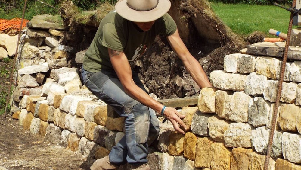 Emma Knowles adding stone to dry stone wall