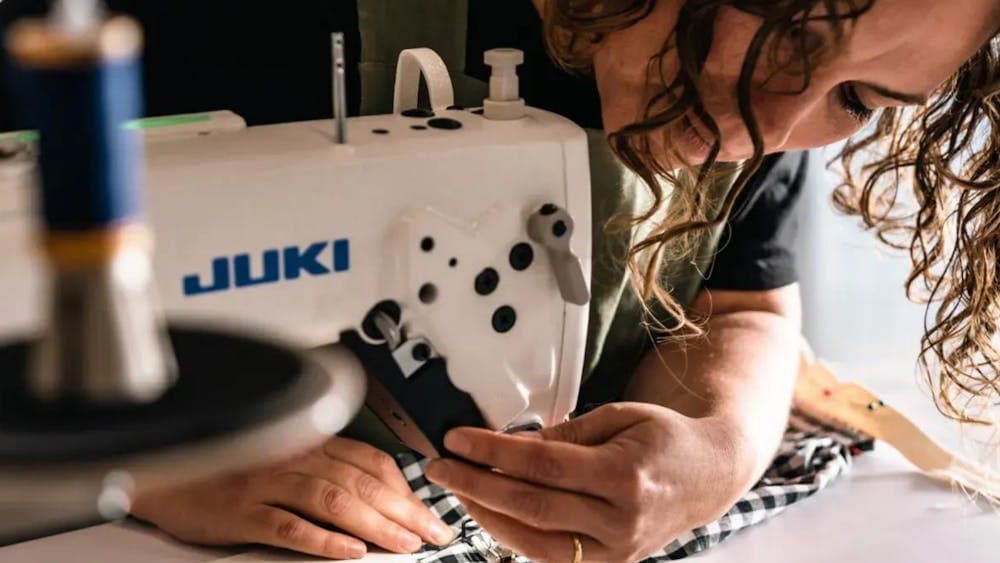 Workshop participant sewing on machine