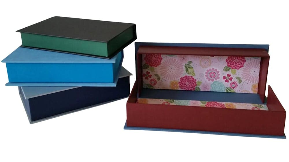 Set of four cloth covered storage boxes