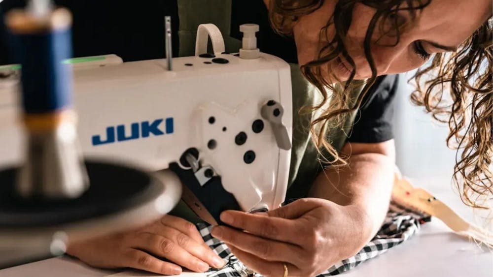 Woman sewing at sewing machine