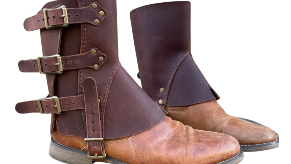 Pair of leather gaiters on brown leather boots