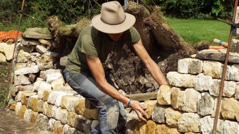 Emma Knowles adding stone to dry stone wall