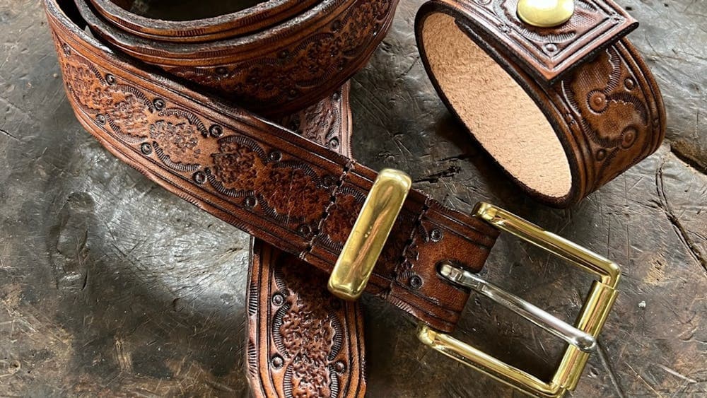 Two stamped brown leather cuffs