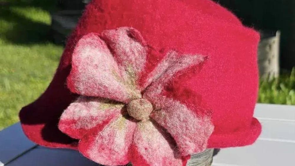 Red felt hat with pink felt flower