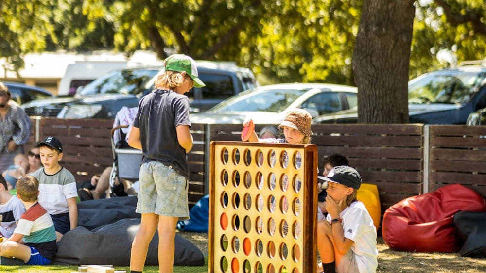 Children playing Giant Connect 4 in a park