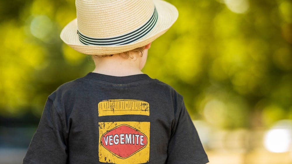 Young boy from behind, wearing cool t-shirt and hat