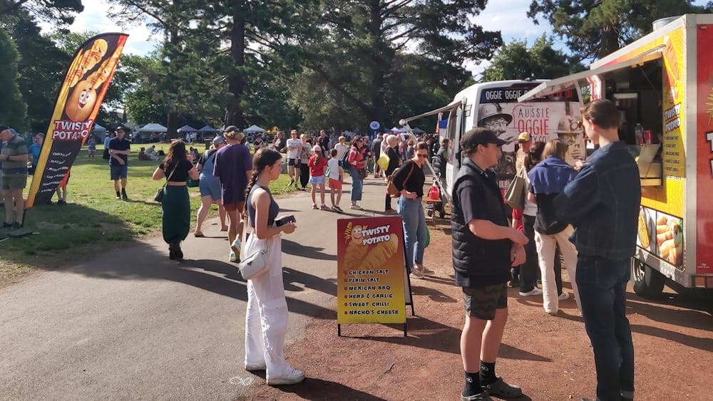 Shoppers and market food vans