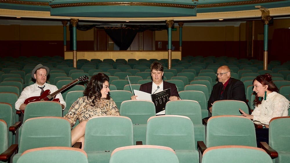 musicians and performers getting ready to perform in the auditorium of Her Majesty's Theatre