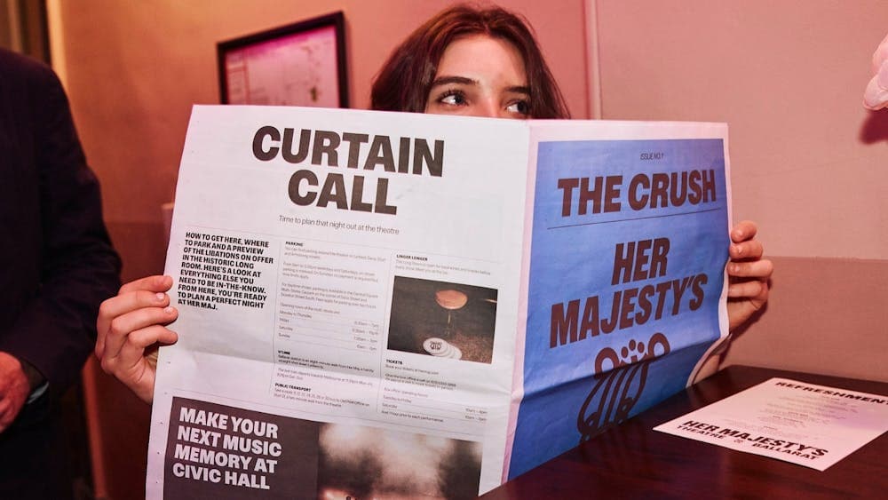 A girl holding a broadsheet