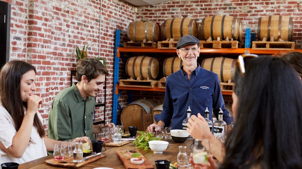 A table of people being led through a guided gin tasting session