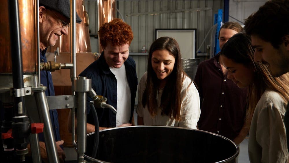 A small group of people looking into the still as part of the Kilderkin Distillery tour