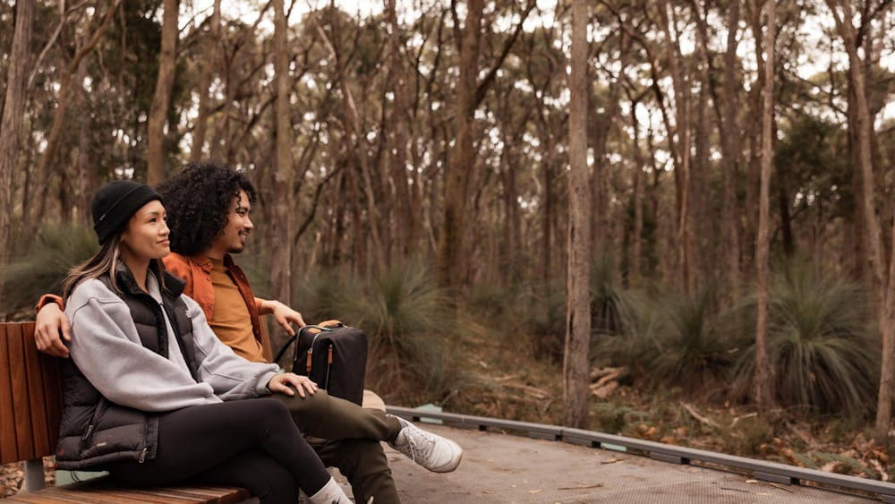 A couple relaxes at Woowookarung Regional Park trail