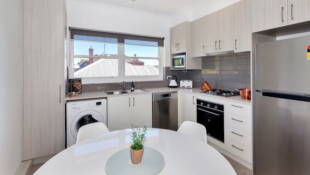 Full kitchen with dishwasher, stove, oven, fridge, freezer, toaster and kettle