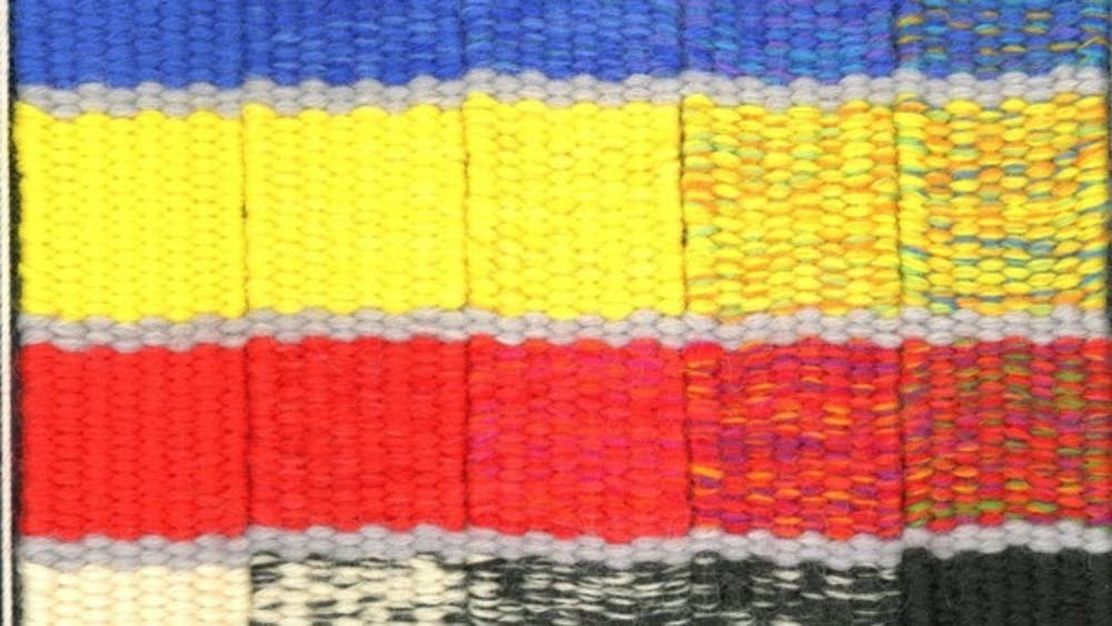 Blue, yellow, red and black diagonal stripped tapestry