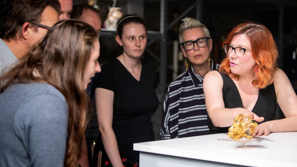 Curator showing gold nugget to tour group