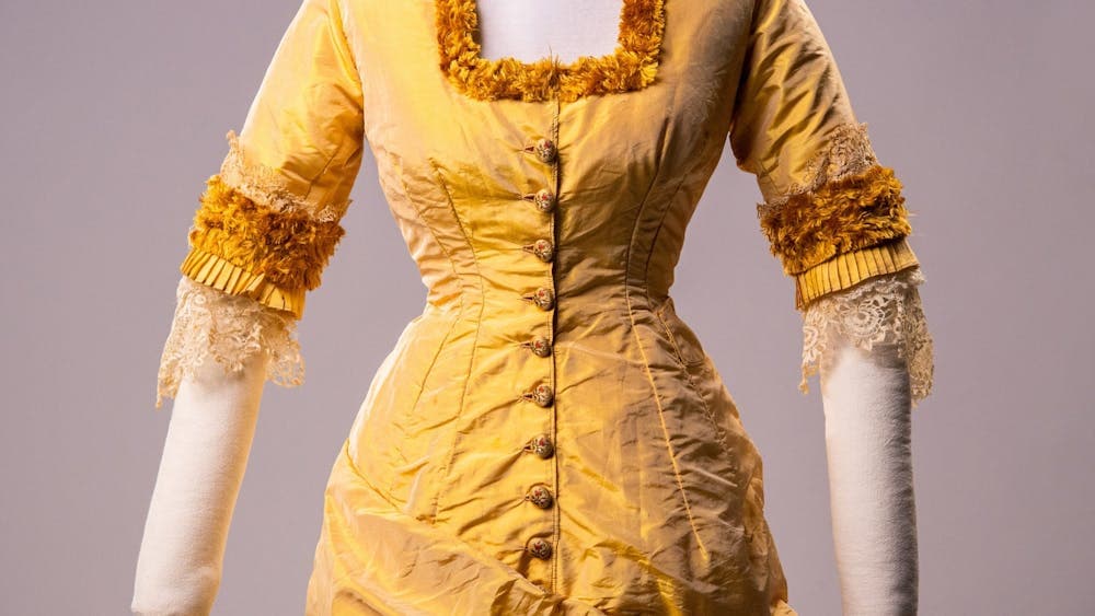 Historical gold dress mounted on mannequin