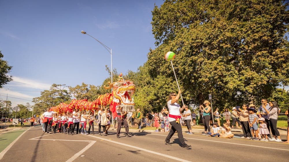 The red and gold Chinese dragon is being carried through the festival