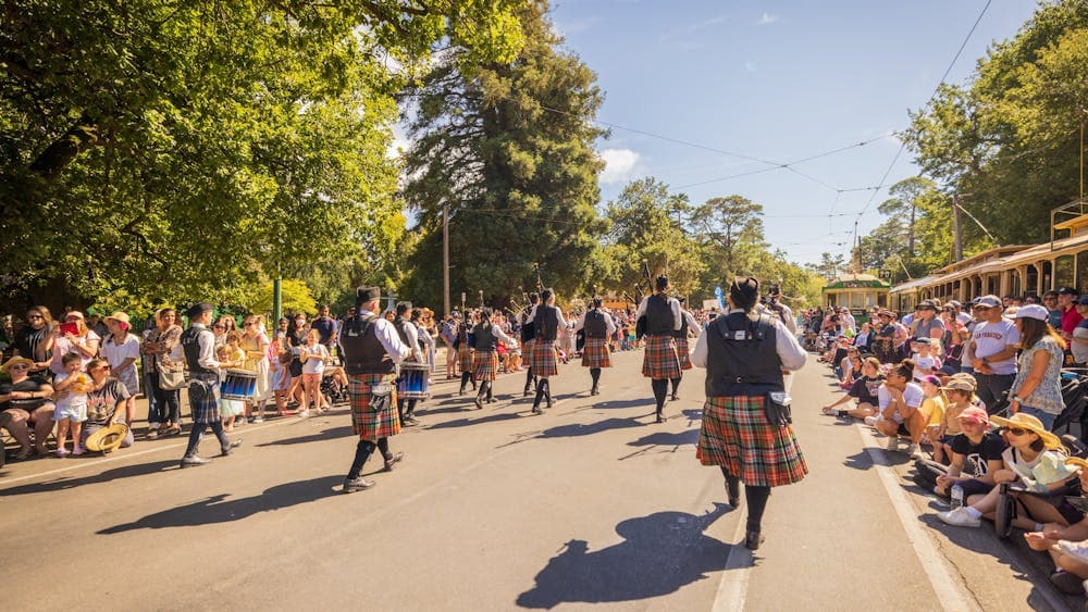 The photo shows the Scottish Highland Group of Ballarat from behind while they walk in the parade