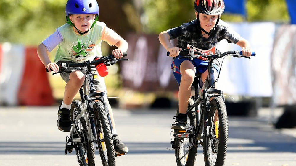 Two young boys showing their determination as they ride around Lake Wendouree