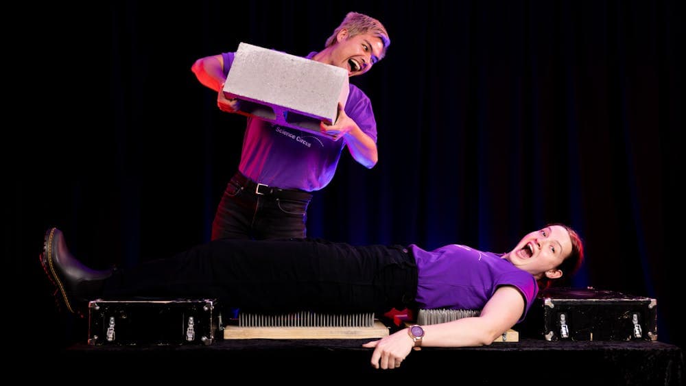 Questacon presenters performing bed of nails demonstration