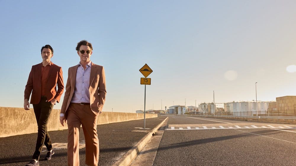 Bernard Fanning and Paul Dempsey strutting down an empty Australian road