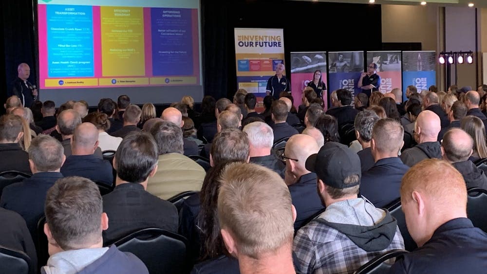 People sitting in rows of chairs facing the front for a presentation