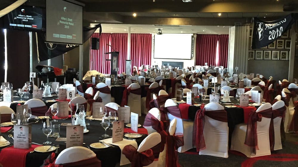 function room set up with seat covers & table decorations