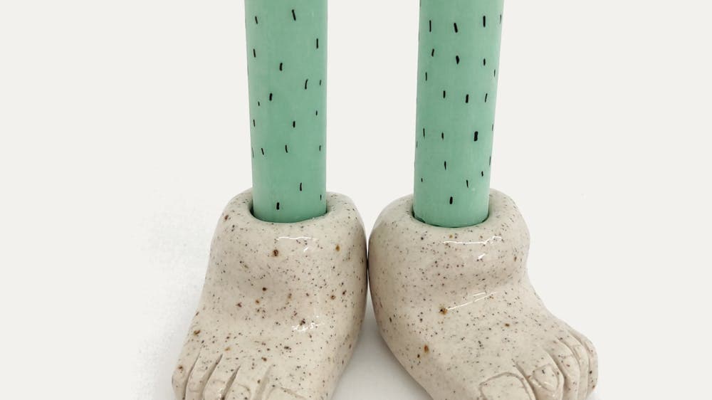 a pair of handmade ceramic feet