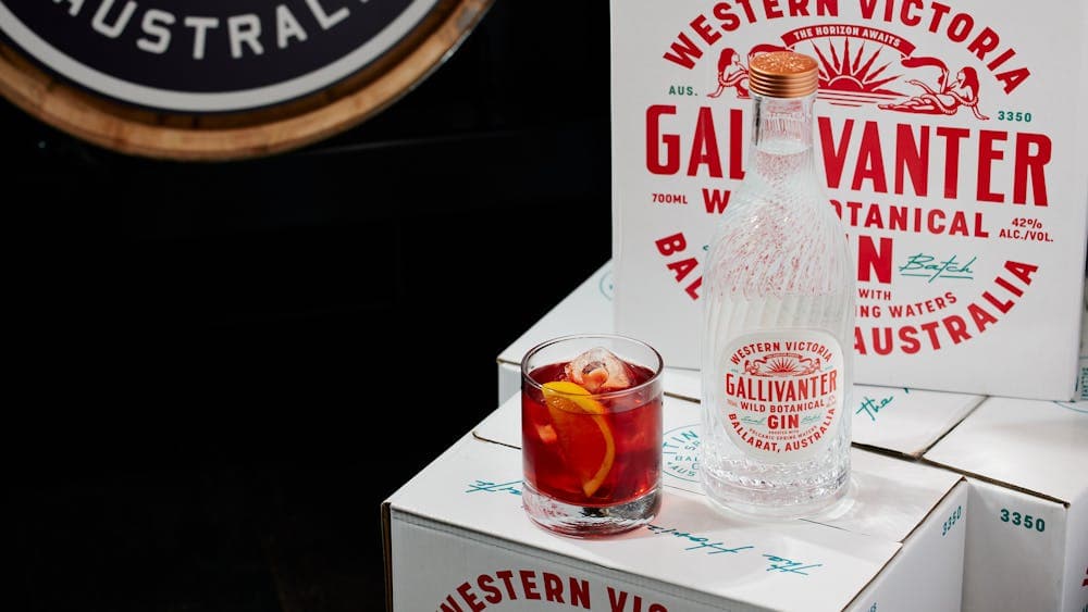 Cocktail with Gallivanter Gin Bottle and branded boxes