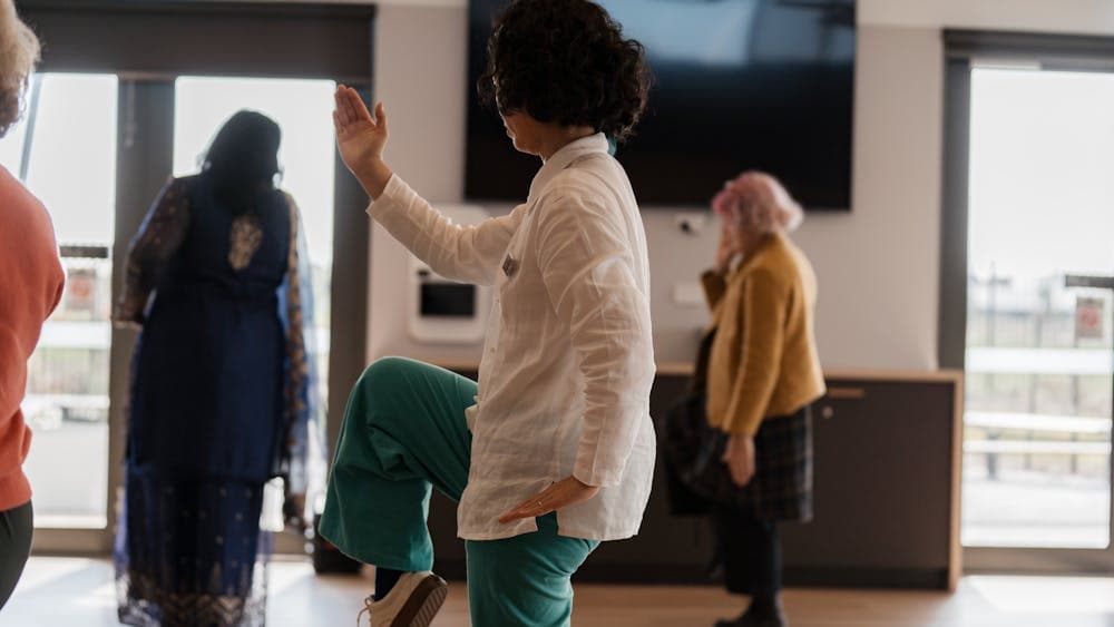 People with arms partly raised in QiGong movement