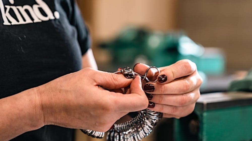 Close of a pair of hands selecting rings