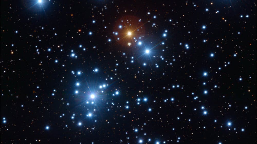 Open Cluster of Bright Blue Stars, 1 Bright Red Stars, saller fainter red white and blue stars