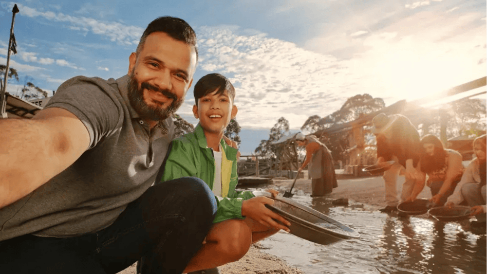 Dad and son taking a selfie while panning for gold