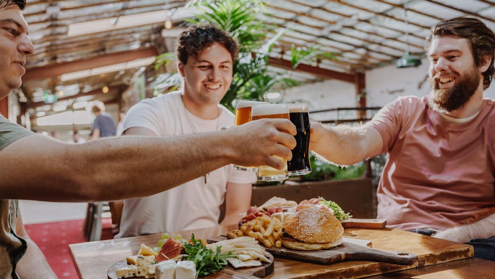Three friends with beers in hand