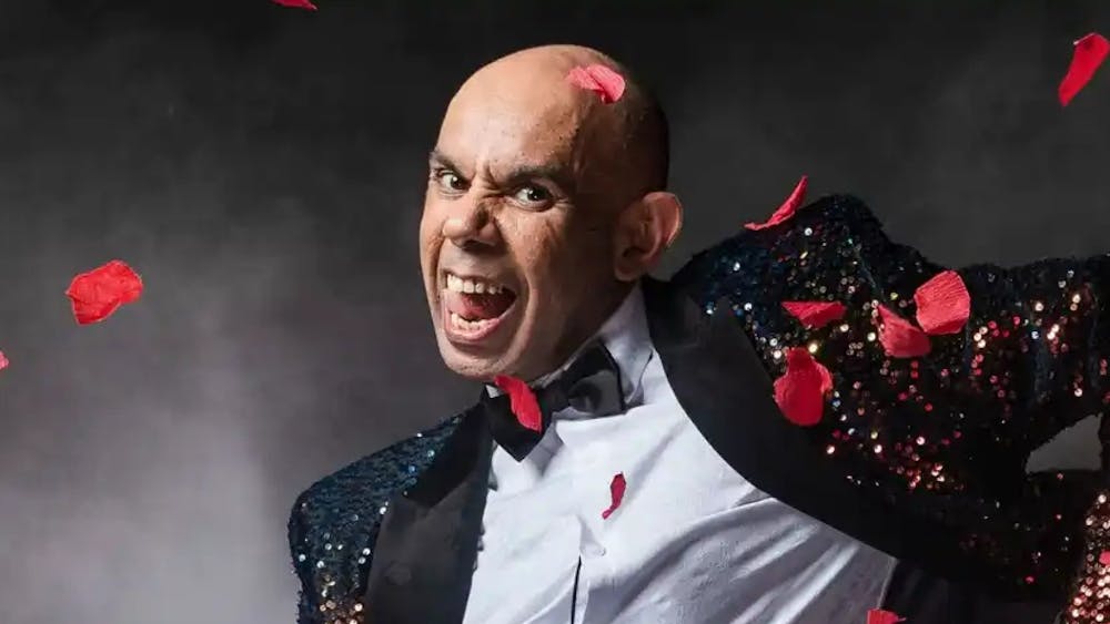 enthusiastic portrait of Steven Oliver with red flower petels